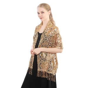 Detail view of elegant golden sequin shawl with fringes on female model