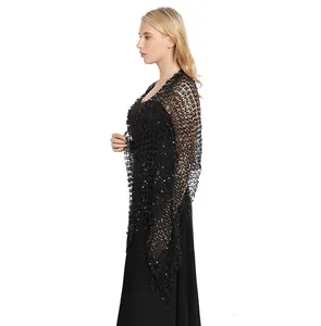 Detailed side view of a black sequined evening shawl with elegant tassel fringe.