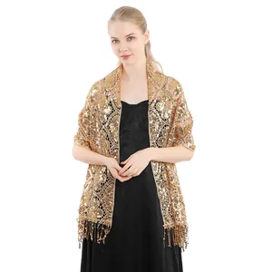 Close-up of elegant gold sequin shawl with fringe details on model