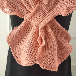 Close-up of pink knitted shawl texture showing intricate mesh patterns and fishtail hem