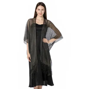 Detailed view of an elegant black shimmering metallic thread shawl with fringes