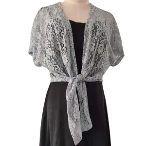 Close-up of the delicate floral lace pattern on this light blue tie-front bolero