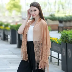 Elegant peach lace shawl featuring intricate floral patterns and delicate fringe detail