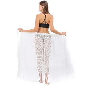 Rear view of a white lace beach sarong wrap skirt featuring intricate fringe details