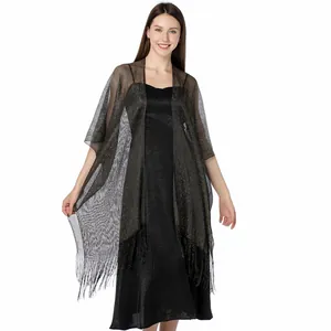 Detailed view of shiny gold metallic thread shawl wrap with fringe edges for evening dress