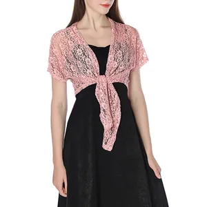Close-up of the delicate pink floral lace fabric and tie-front knot detail of the shrug bolero