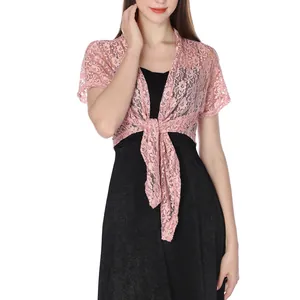 Model wearing pink floral lace shrug with tie-front detail over black dress.