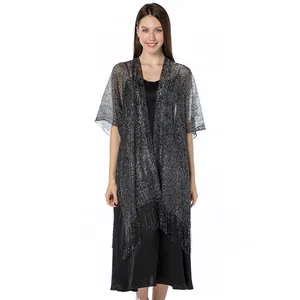 Detailed view of elegant silver metallic sparkling shawl with fringe on model
