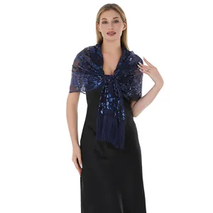 Close-up detail of navy blue sequin embroidered wrap shawl with tassels on female model