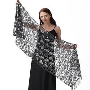 Close-up detail of a black sequined paisley lace shawl wrap for elegant evening wear