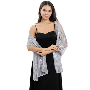 Elegant grey mesh shawl with sequined peony embroidery worn over a black gown.