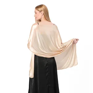 Back view of elegant champagne gold satin shawl draped over a black evening gown
