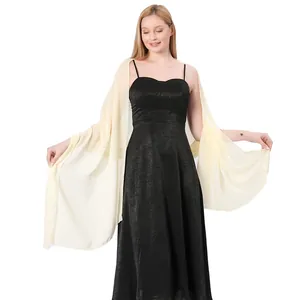 An elegant ivory chiffon shawl wrap beautifully draped over a black evening dress on a model