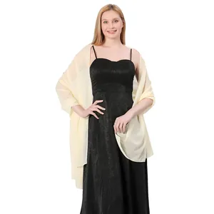 Elegant long beige chiffon shawl scarf draped on black dress for bridesmaid party