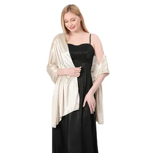 Champagne gold satin bridal shawl gracefully draped over an elegant black dress
