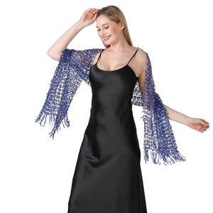 Close-up detail of an elegant blue sequined embroidered shawl worn over a black dress