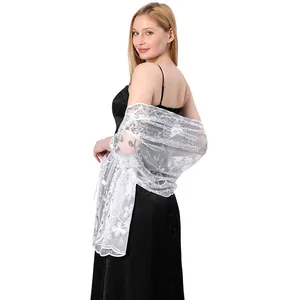 Elegant white floral lace shawl with shimmering sequins over a black evening dress