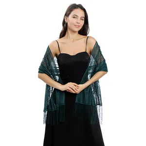 Elegant dark green lace shawl with fringe detail shown on model with evening dress