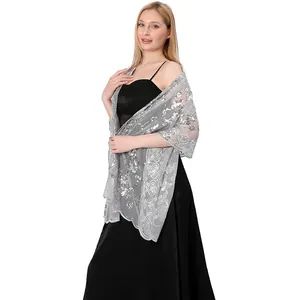 Close-up of elegant silver sequined mesh shawl with heart and floral embroidery