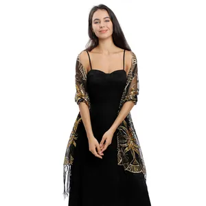 Detail shot of black mesh shawl with gold sequin embroidery and tassels for parties