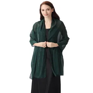 Elegant dark green chiffon shawl with silver threads and rhinestones worn by a model