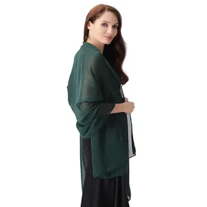 Side view detail of a dark green chiffon shawl with silver threads and rhinestones.