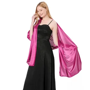 Close-up detail of fuchsia satin shawl draped elegantly over a black evening dress.