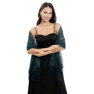 Elegant dark green lace evening shawl with fringe details on a black party dress