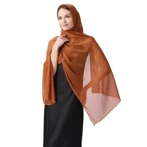 Detail view of brown chiffon shawl with silver silk thread and sparkling rhinestones