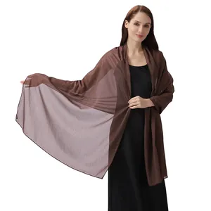 Close-up detail of a brown shimmering silk crepe shawl for elegant evening party wear