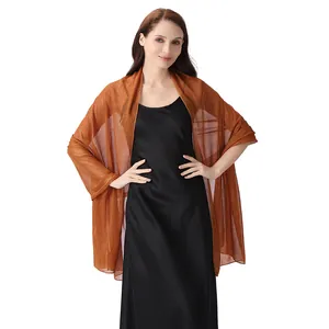 Elegant sheer chiffon shawl with metallic shimmer worn over a black evening dress