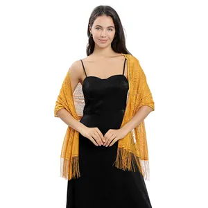 Detail shot of an elegant yellow floral lace shawl with fringe tassels for evening wear