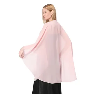 Detailed back view of a flowy light pink chiffon shawl cape for bridal evening wear