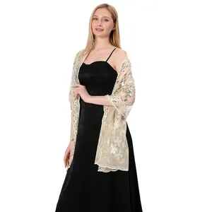 Full view of elegant champagne sequin shawl styled with a black formal evening gown