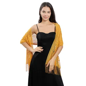 Elegant yellow lace shawl with fringe detail worn over a black formal evening dress