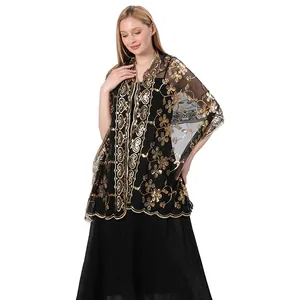 Detailed view of the black sheer shawl with intricate gold floral sequin embroidery
