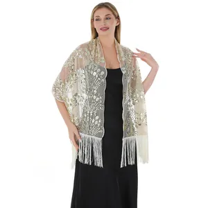 Close-up view of golden sequin embroidery and fringe details on luxury evening shawl