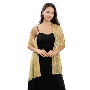Detail of elegant gold sheer shawl with sequined peony embroidery for bridal wear