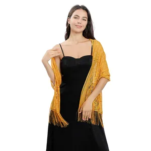 Detailed close-up view of yellow floral lace evening shawl with elegant tassel fringe finish