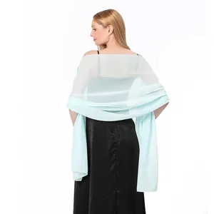 Back view detail of a light blue chiffon shawl draped over a black evening dress.