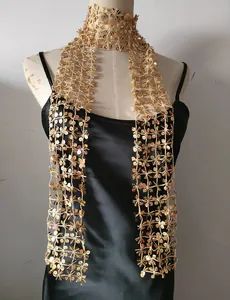 Close-up of golden sequined mesh scarf on mannequin for party styling