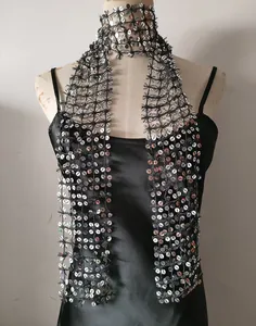 Detail view of black mesh scarf with sparkling silver sequins for glamorous party wear.