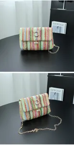 Detailed view of a colorful striped woven crossbody bag with pearl charms and gold chain