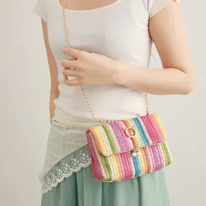 Colorful woven crossbody bag with gold chain strap, cat clasp and pearl charms.