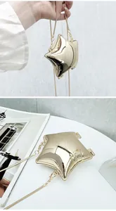 Detailed view of a gold star-shaped acrylic mini crossbody bag with a sleek chain strap
