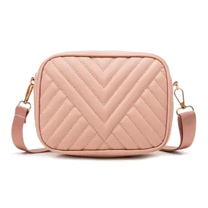 Elegant pink quilted crossbody camera bag with chic chevron embroidery