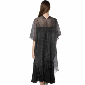 Back view of a shimmering black metallic lurex shawl with fringe trim detail.