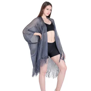 Elegant metallic yarn shawl with fringe detail, perfect beach holiday bikini cover-up