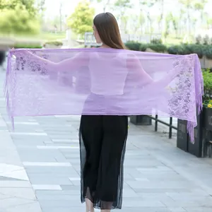 Macro detail of elegant purple lace shawl featuring floral patterns and delicate fringe