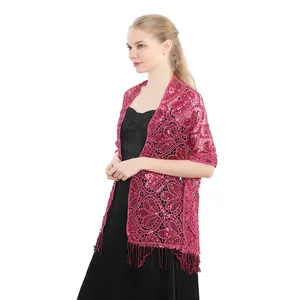 Close-up of elegant burgundy sequin tassel shawl over black evening dress